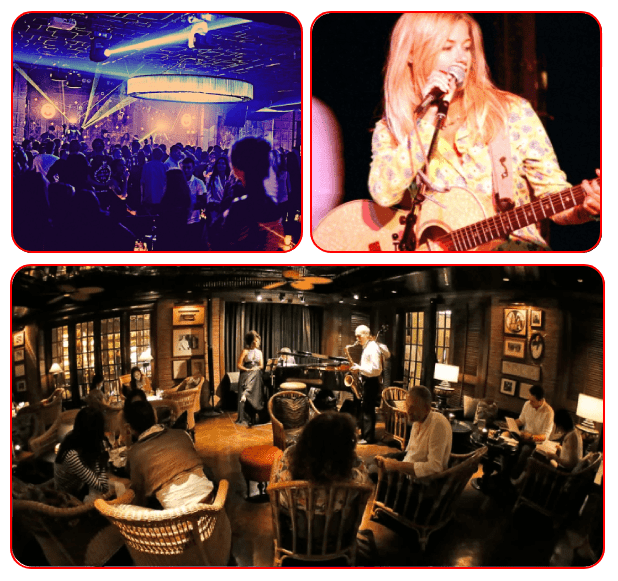 A group of people sitting in chairs and a stage with a woman playing guitar.